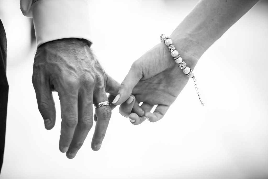 Hands lightly holding to each other.