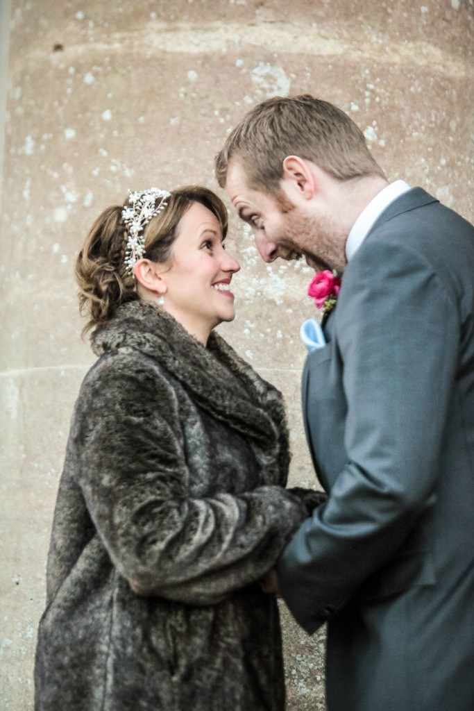 Fun and relaxed wedding image of couple, bride and groom happy and laughing.