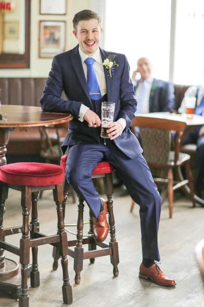 Wedding photographer captures natural and relaxed pose by this groom.