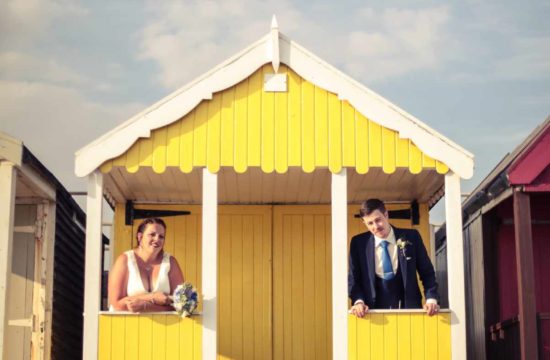 Real wedding in Essex. A couple stand in a beach hut. Wedding Photography. your perfect wedding photographer.