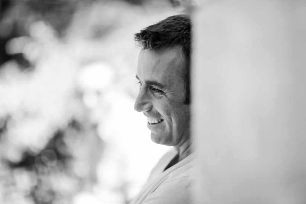 A a guest getting ready in a mirror in a french house during his wedding. Creative edit in black and white.