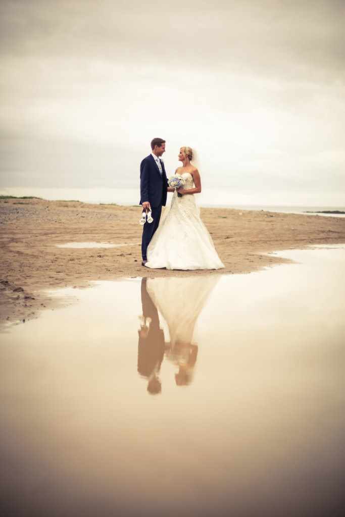 Couple on a beach during their wedding.