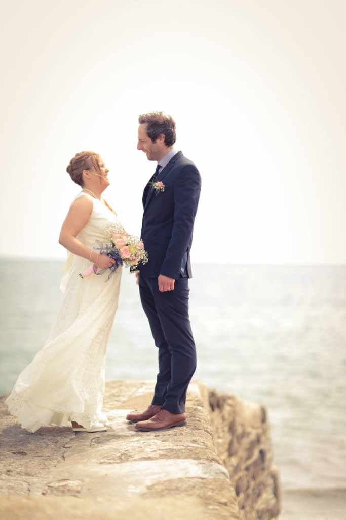 Couple on the coast after getting married.