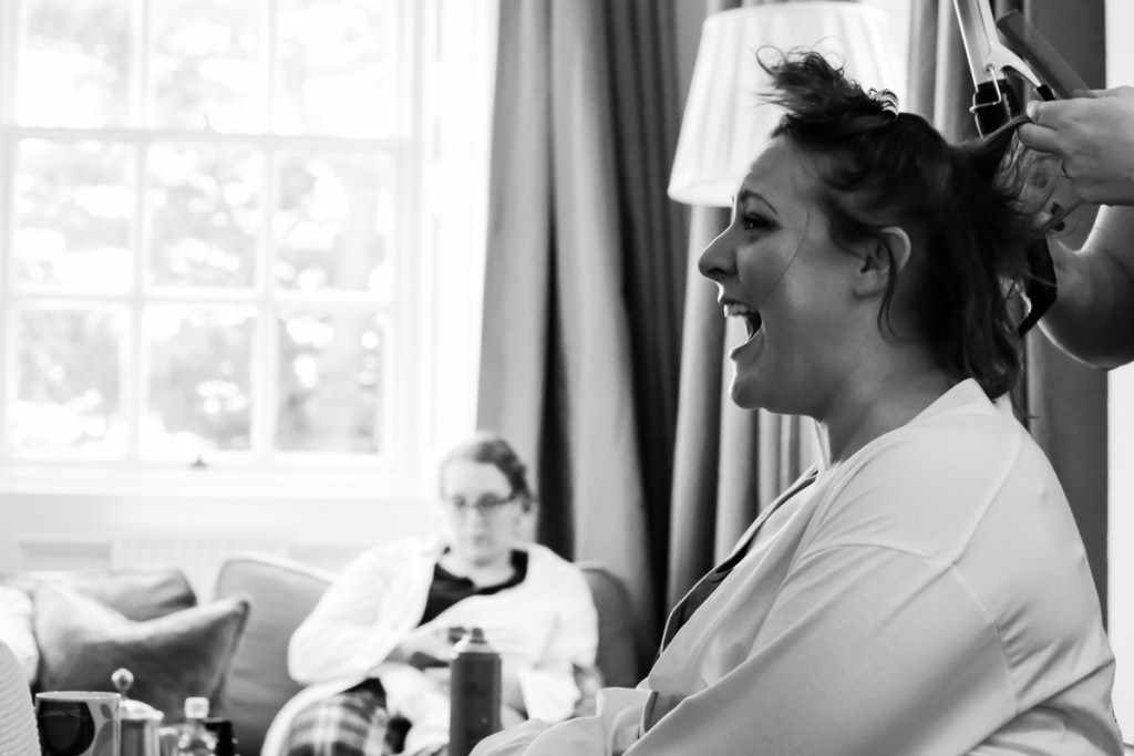 A laughing bride wedding by a Cornwall wedding photographer