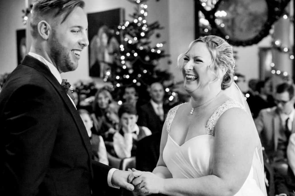 Laughing bride and groom at a wedding by a Cornwall wedding photographer