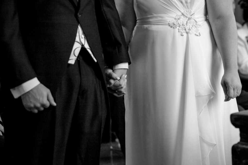 The bride and groom holding hands at a wedding by a Cornwall wedding photographer