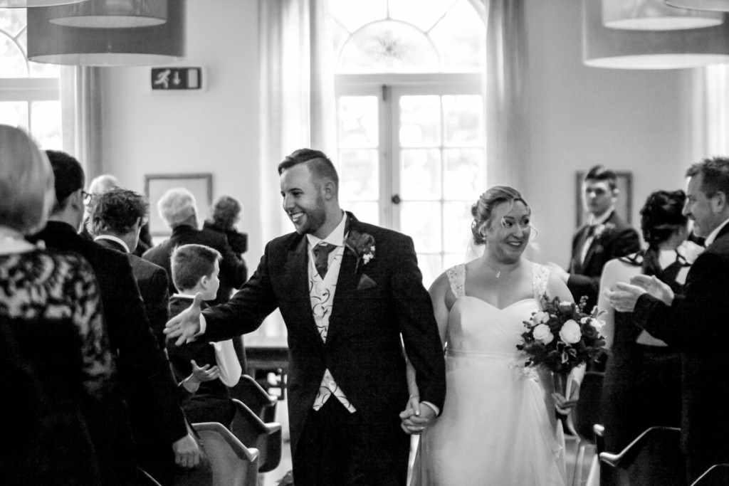 Bride and groom walking down the isle of a Cornish wedding