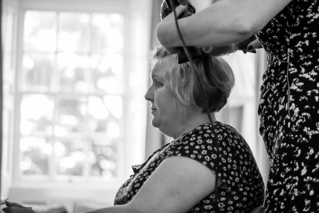 Hair being made at a wedding by a Cornwall wedding photographer