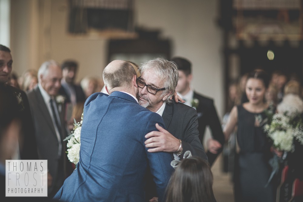 Groom and Father of the bride hugging at Prittlewell Priory Wedding, Southend-on-sea.