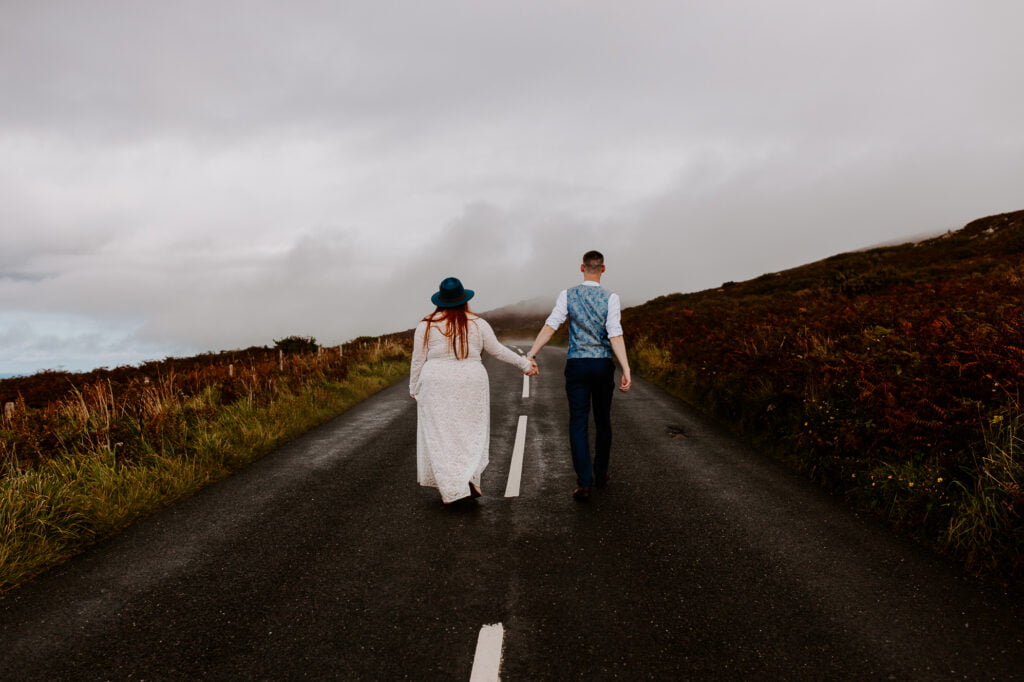 Couple walking down a road eloping