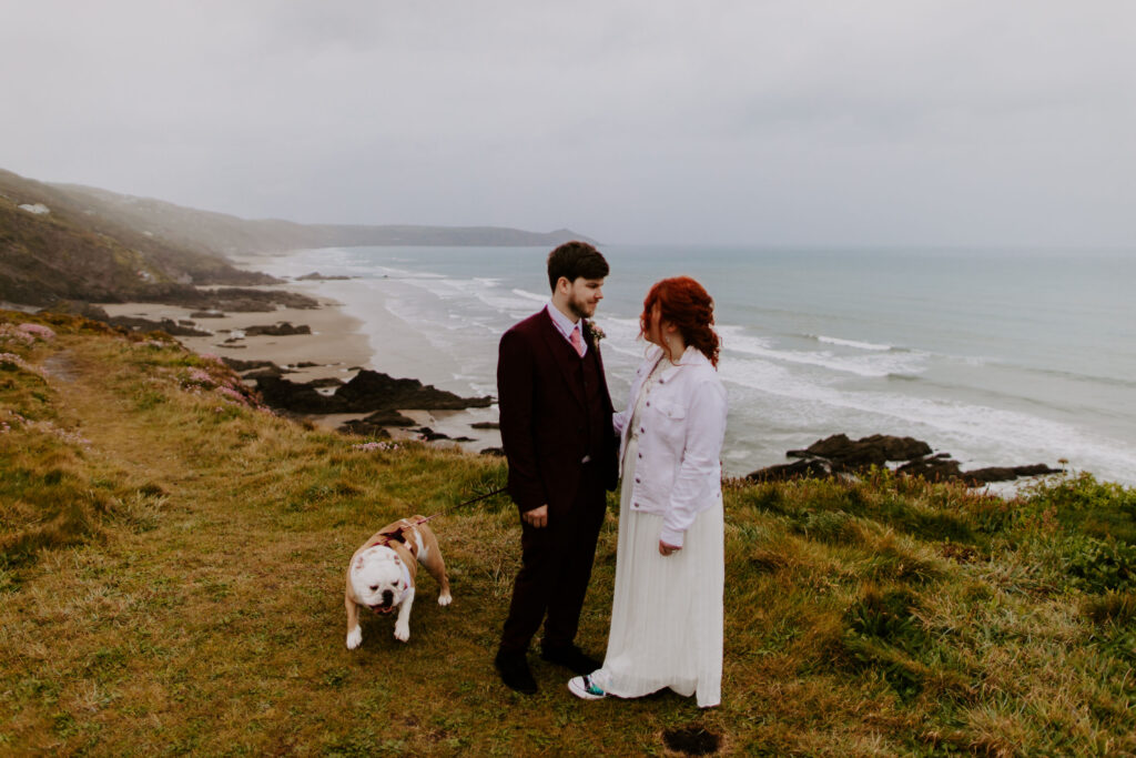 couple at cliff top on their wedding day