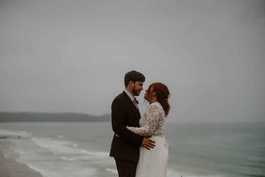 couple embrace at Cornwall elopement wedding