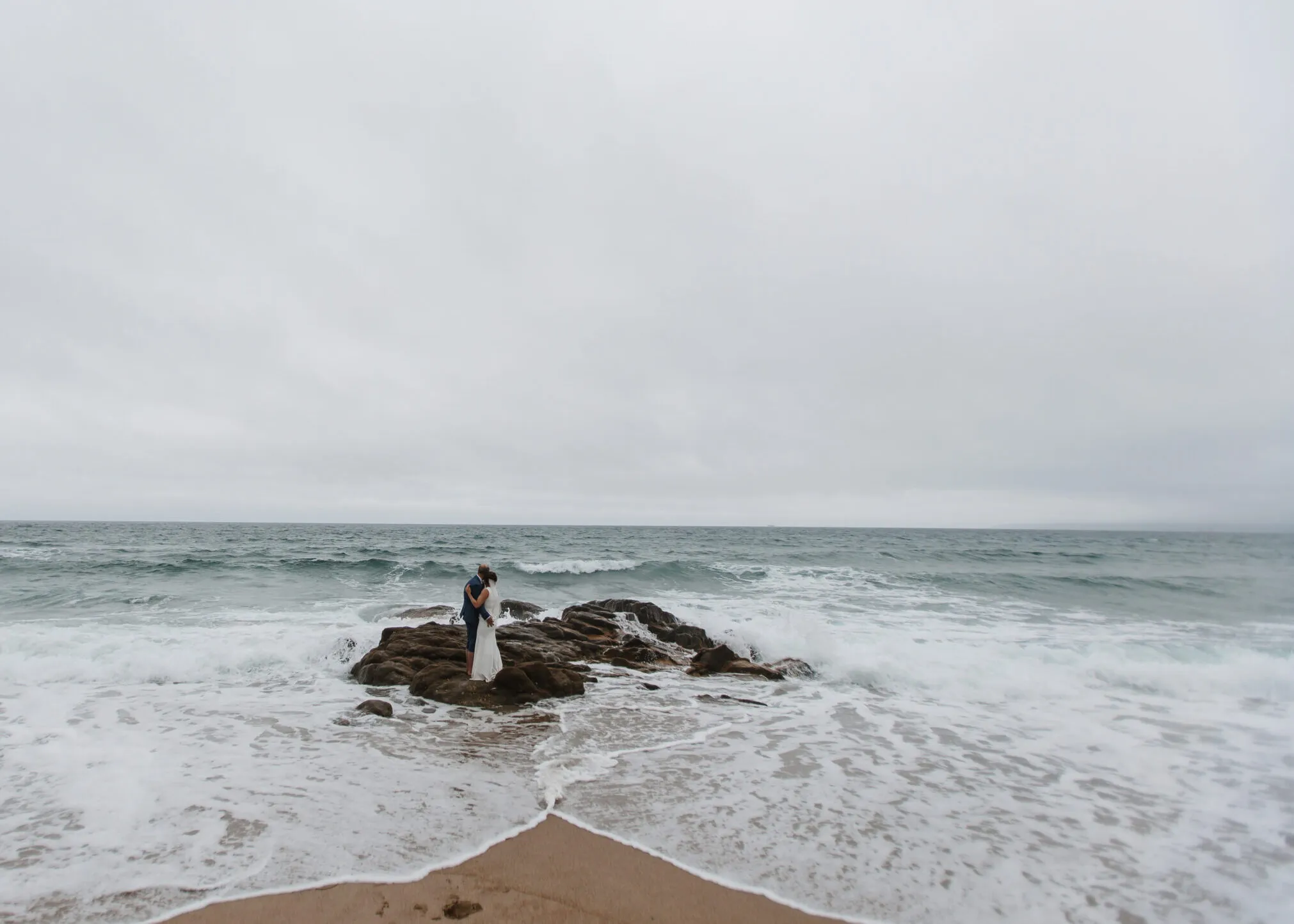 A couple eloping on a beach in Cornwall.